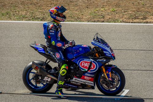 Free Motorcycle racer in PATA Yamaha suit on track at Portimão, Portugal during competition. Stock Photo