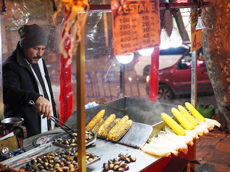 A street vendor in Istanbul roasting corn and chestnuts at night, showcasing Turkish street food culture.