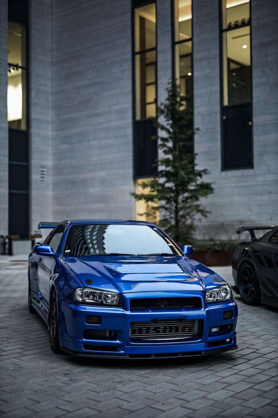 Luxury car parked in front of a hotel entrance