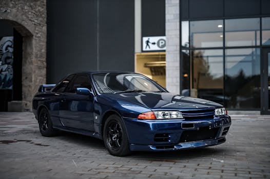 Luxurious navy blue sports car elegantly parked in an urban setting.