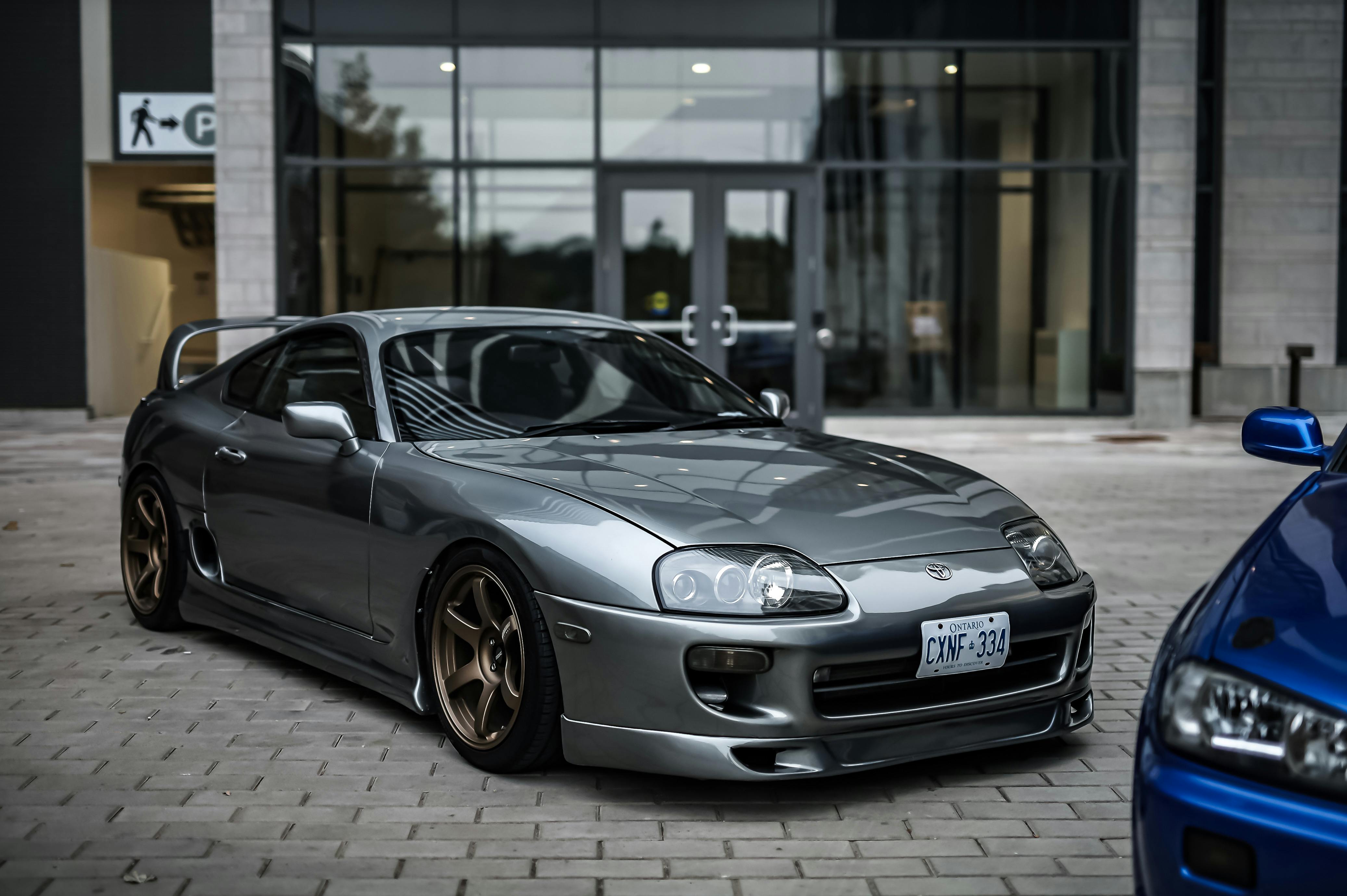 Silver Toyota Supra with Spoiler Parked under Building · Free Stock Photo