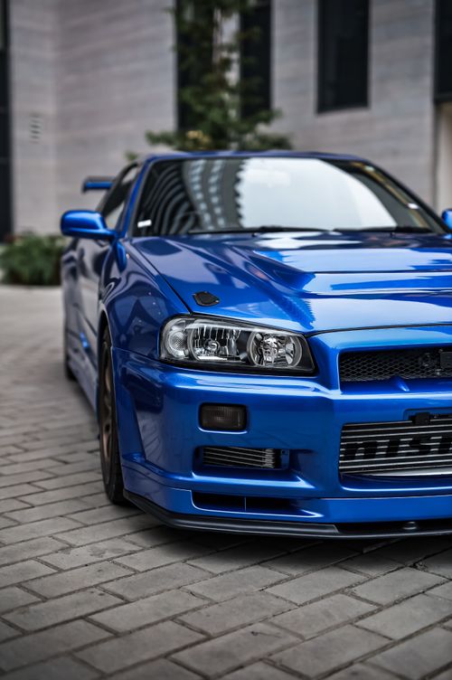 Free Experience the sleek and modern design of a vibrant blue sports car in an urban setting. Stock Photo