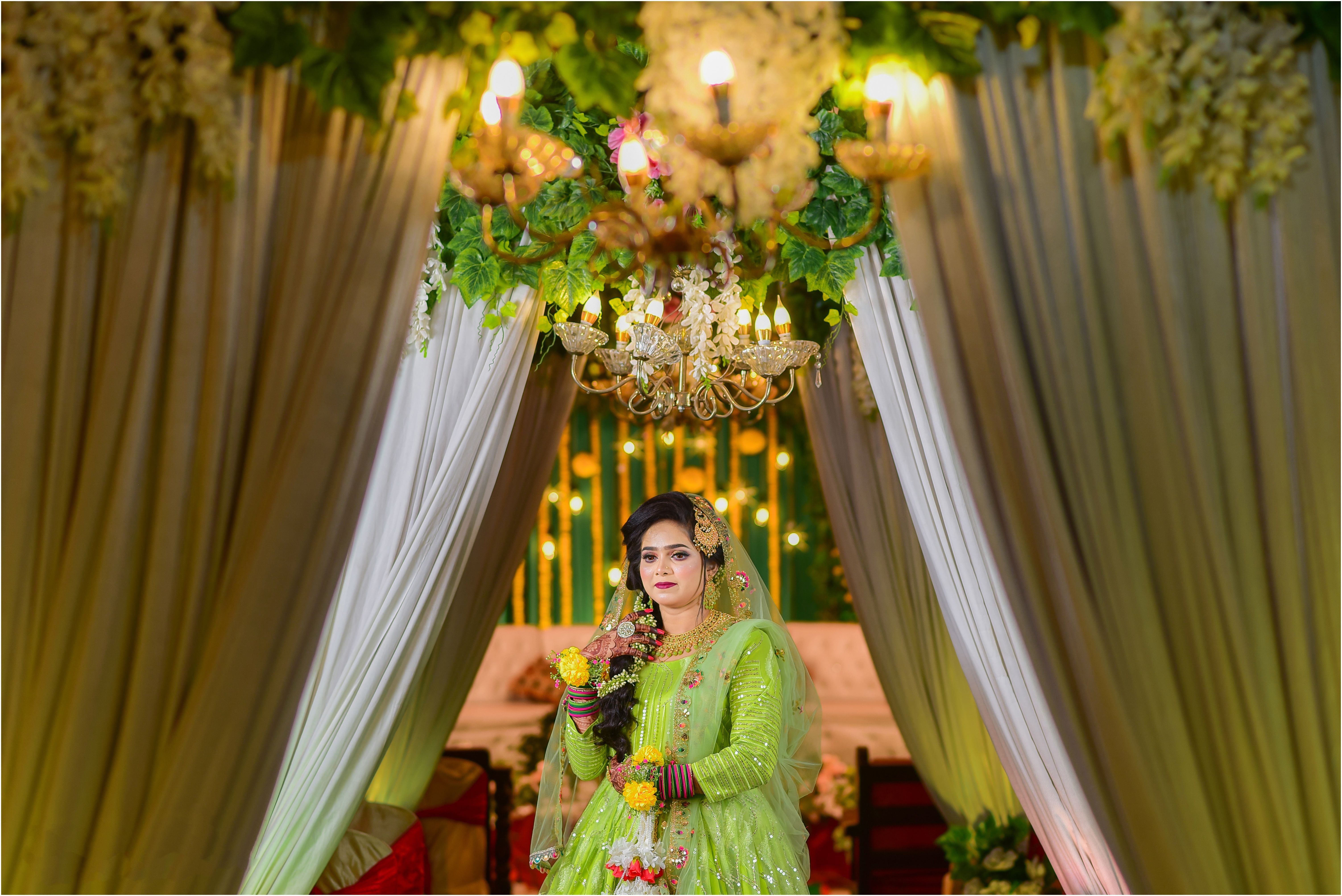 Beautiful bride adorned in green at a Bangladeshi wedding ceremony.