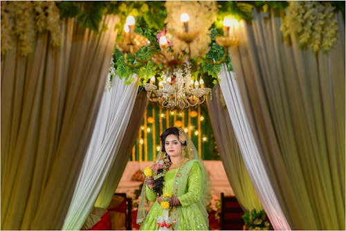 Bride in a Green Wedding Dress Standing in the Aisle