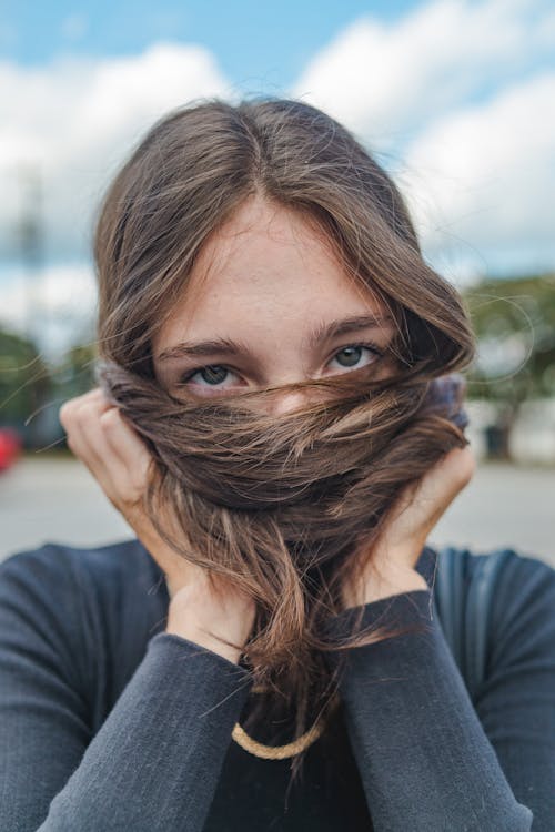 Woman Covering Face with Hair