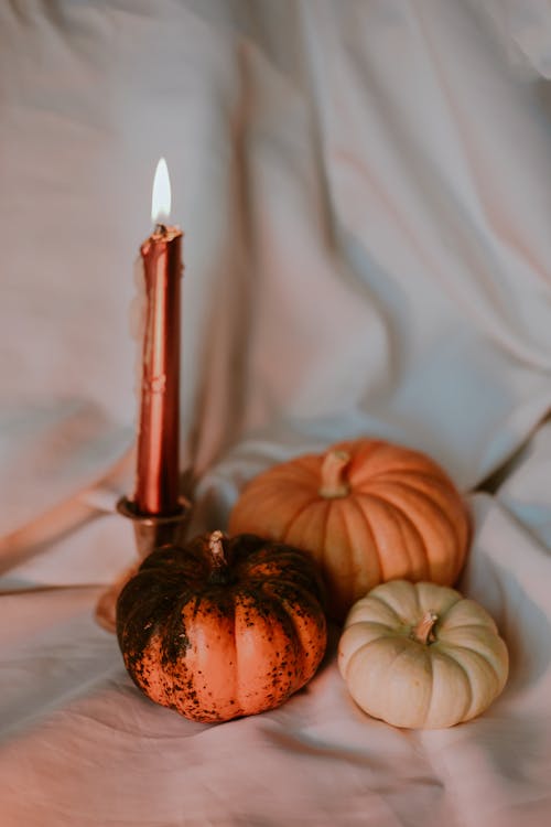 Pumpkins and a Burning Candle 