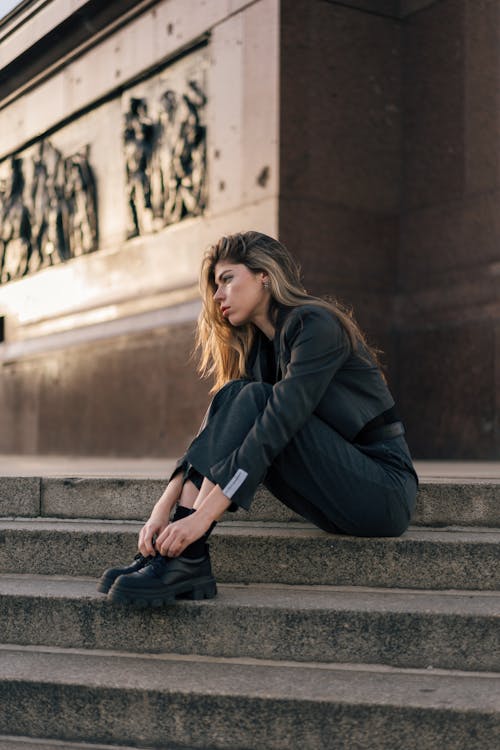 Pretty Blonde Wearing a Gray Jacket Posing on Outdoor Steps