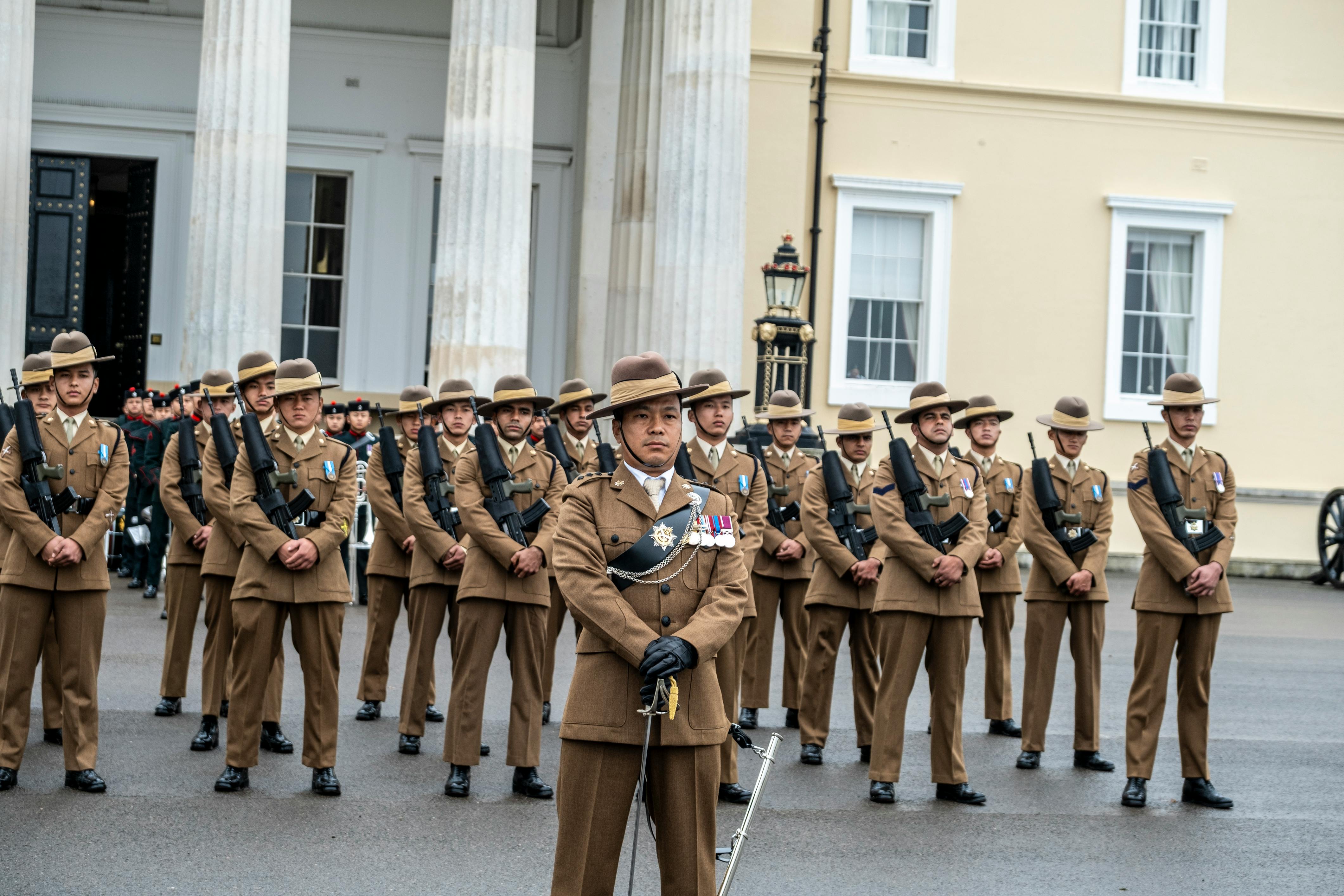 Soldiers in uniform standing in formation at Royal Military Academy Sandhurst, UK.