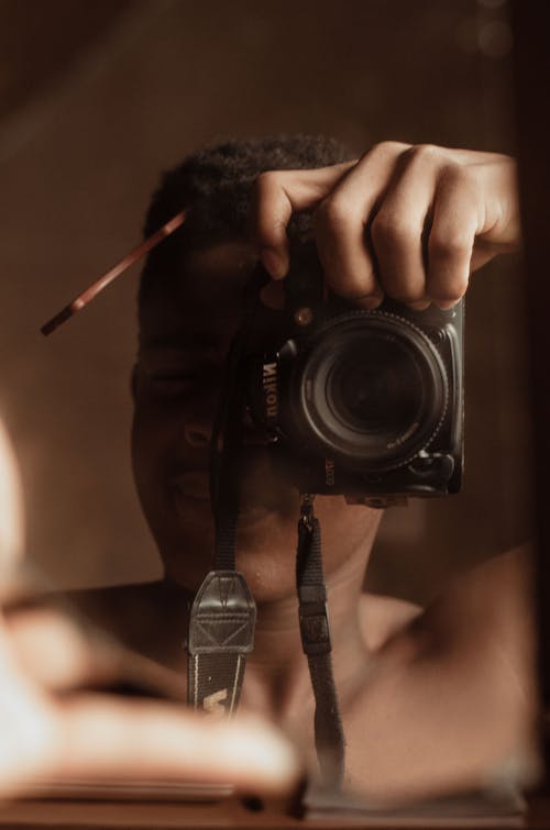 Close up of Man Taking Pictures with Camera