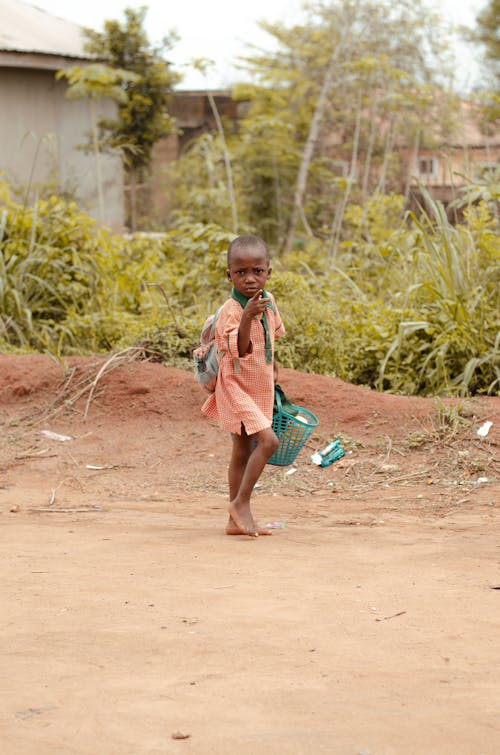 Boy Walking in Village