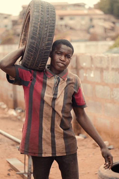 Man Carrying Tire