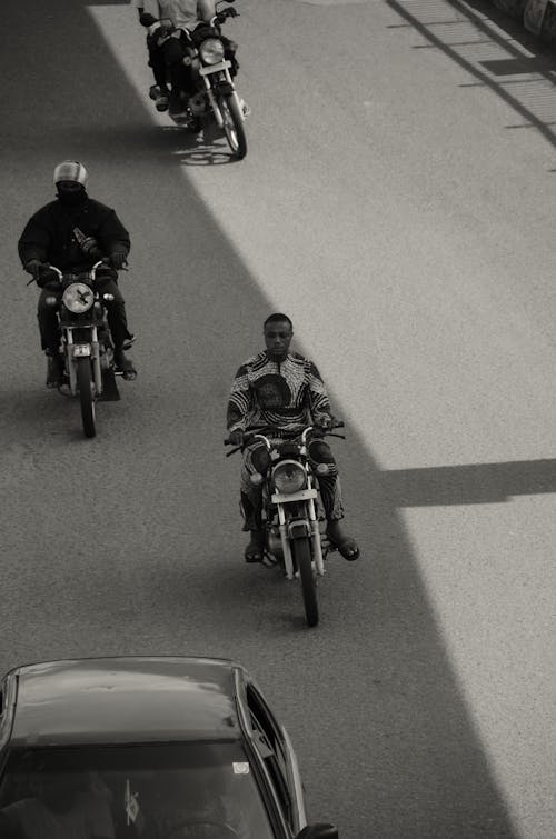 People Riding Motorbikes in Black and White