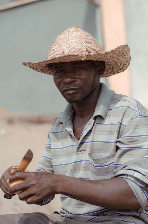 Man in Straw Hat Cut Fruit