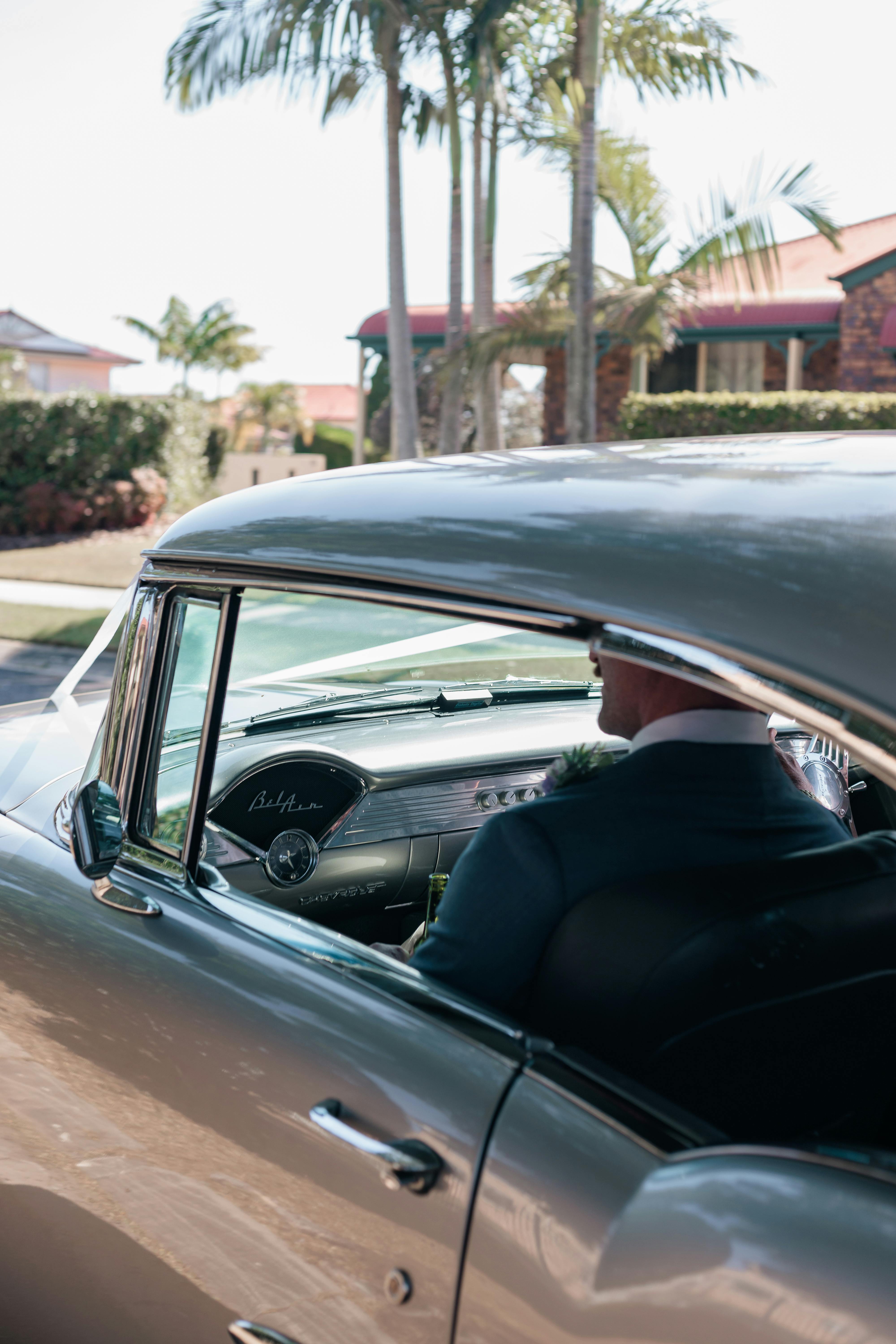 man sitting in vintage chevrolet