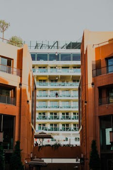 A modern apartment building with balconies, capturing urban living and architecture.