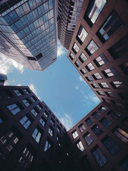 Upward view of Frankfurt skyscrapers framing a clear blue sky.