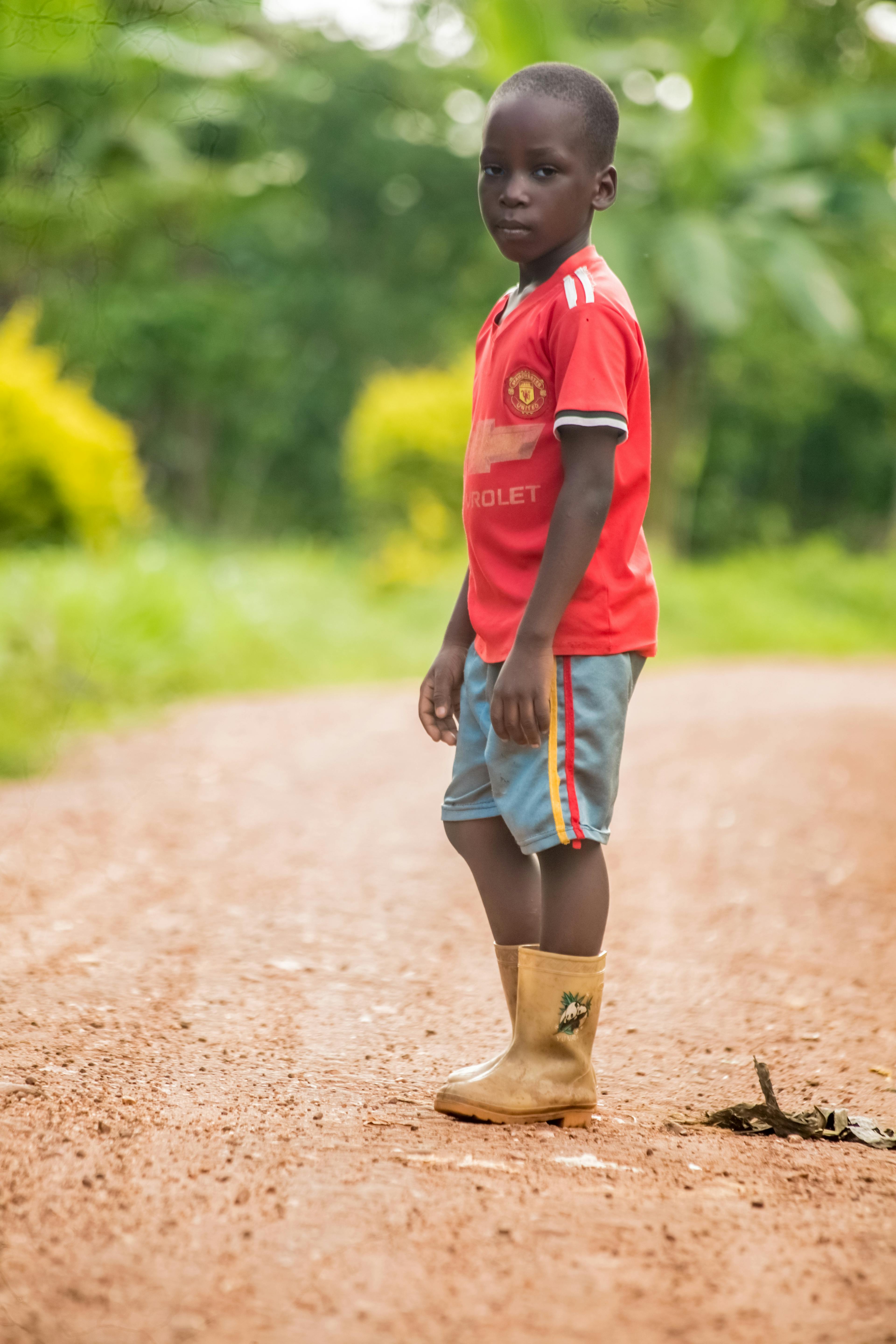 Little African Boy Wearing Rain Boots · Free Stock Photo