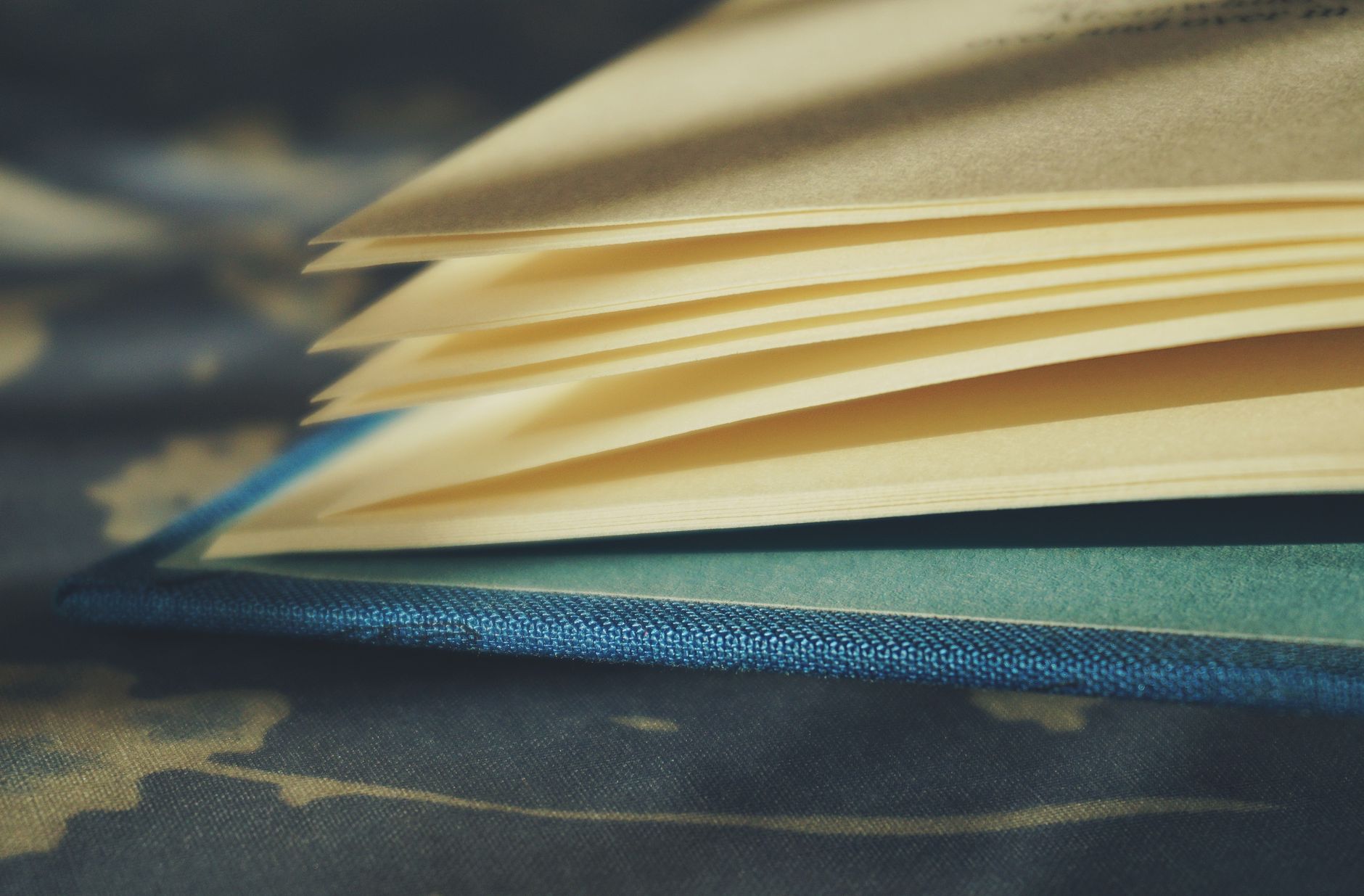 Close-up of an open hardcover book with visible pages