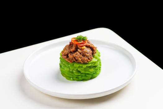 Elegant gourmet dish featuring beef atop melon, styled on a white plate. Perfect for food photography.