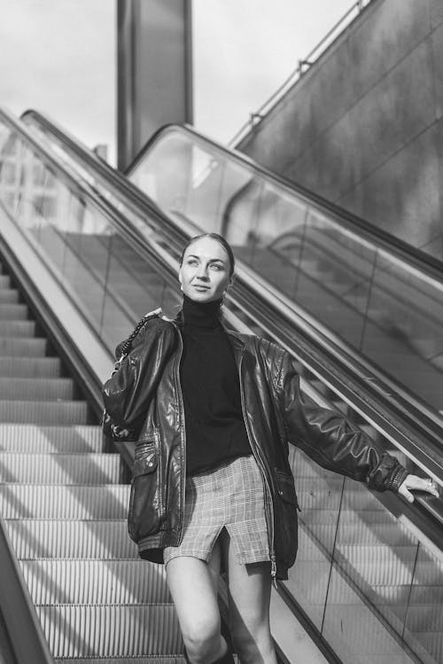 Woman in Turtleneck and Jacket on Escalator