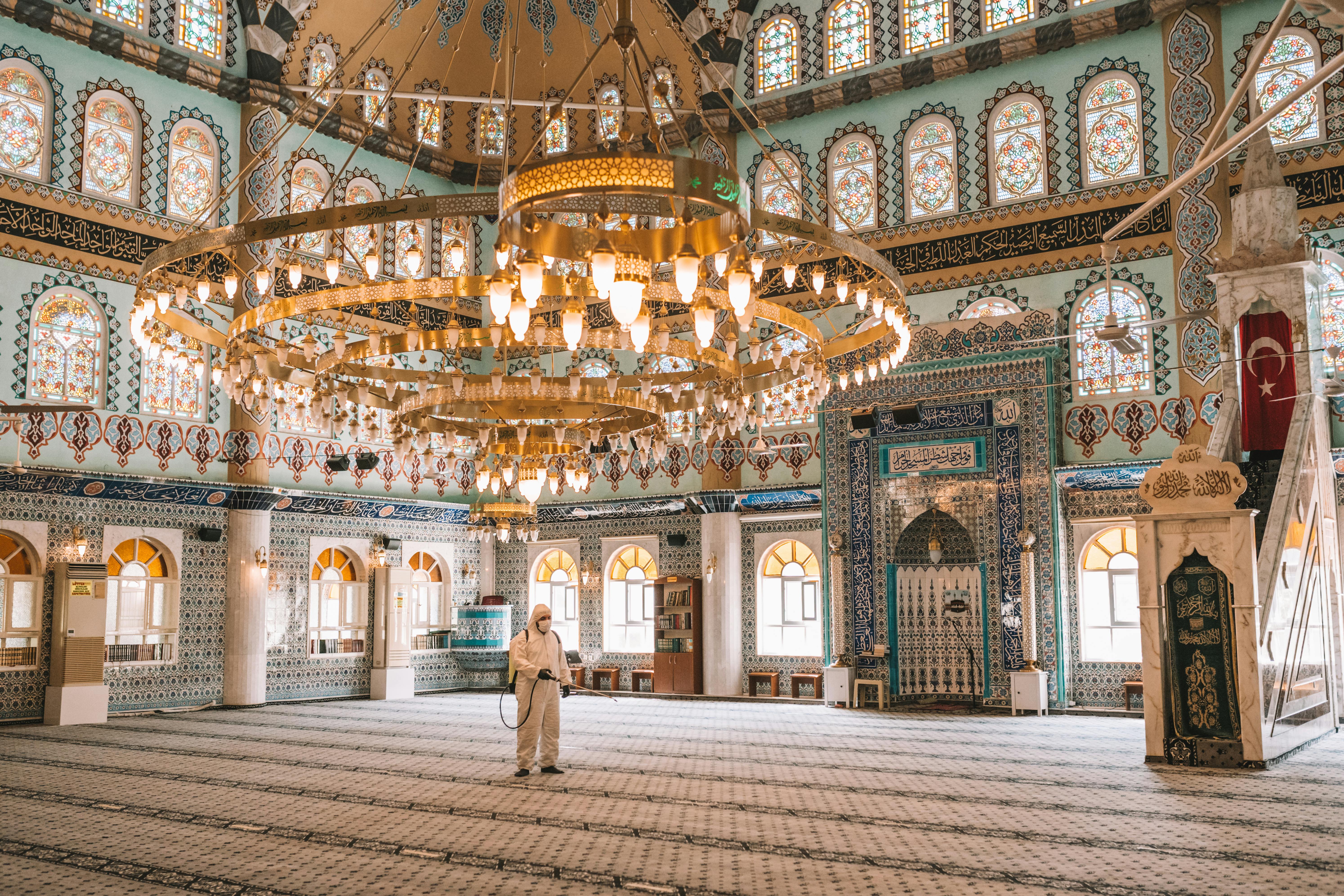 virologist in protective suit disinfects surface sprays liquid chemicals on handrails sanitary measures against coronavirus in public place and mosques covid