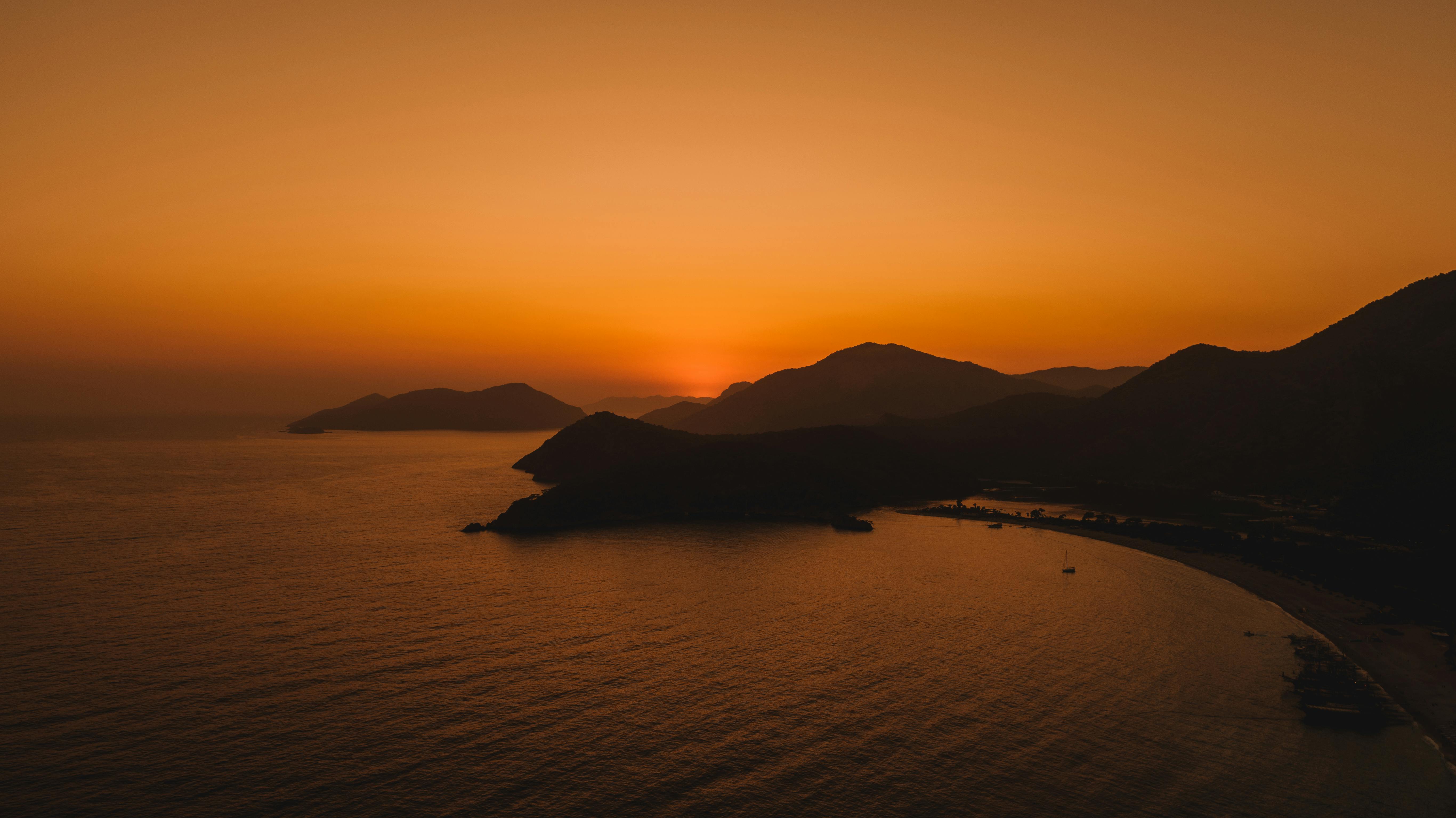 Breathtaking sunset view over the coastline of Ölüdeniz, Türkiye, captured from above.
