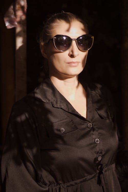 Woman in Black Satin Blouse and Sunglasses