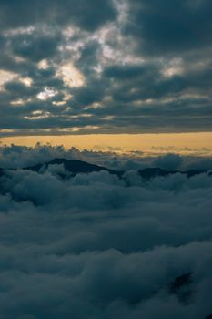 Clouds blanket the mountains of Çamlıhemşin, Rize, Türkiye during a stunning sunset view.