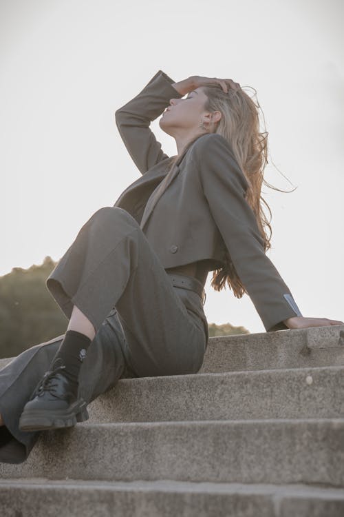 Woman in Black Cropped Blazer and Pants Posing on Steps