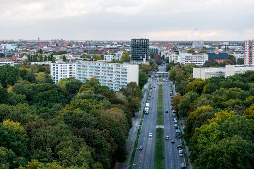 Bird's eye view of a Berlin cityscape featuring urban greenery and modern architecture.