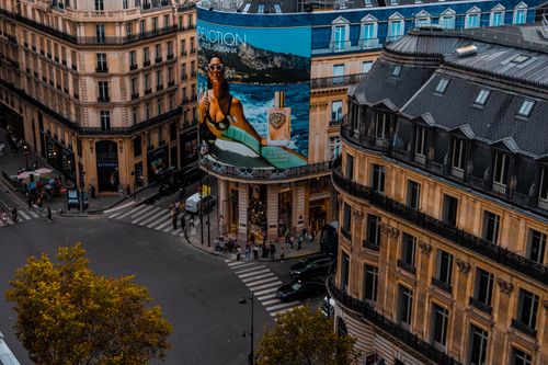 Free A lively urban intersection with billboards and classic architecture. Stock Photo