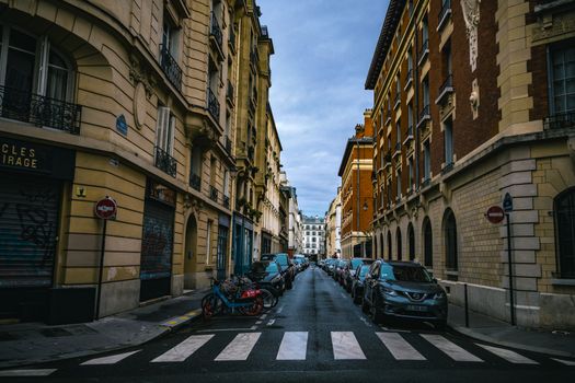 A picturesque Parisian street featuring classic architecture and parked bicycles, capturing the essence of city life.