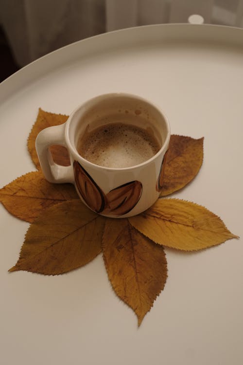  Still Life with a Mug of Cappuccino and Yellow Leaves