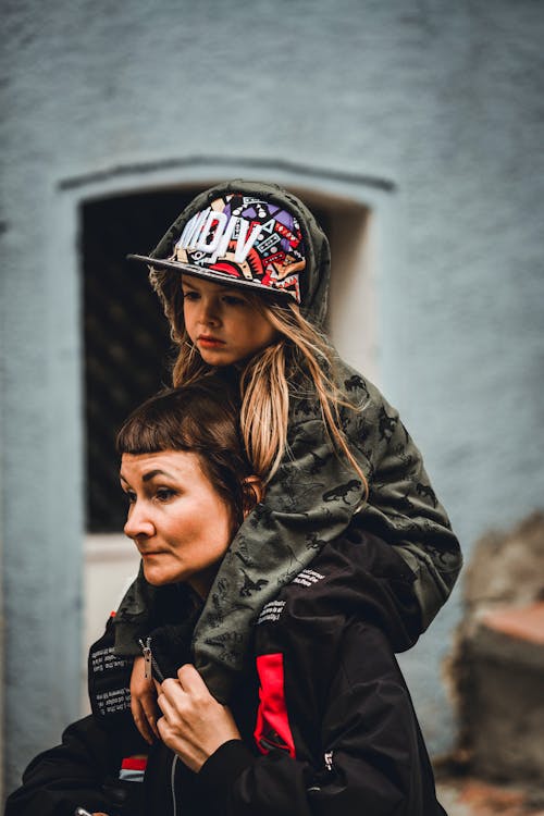 Woman Carrying Daughter Piggyback