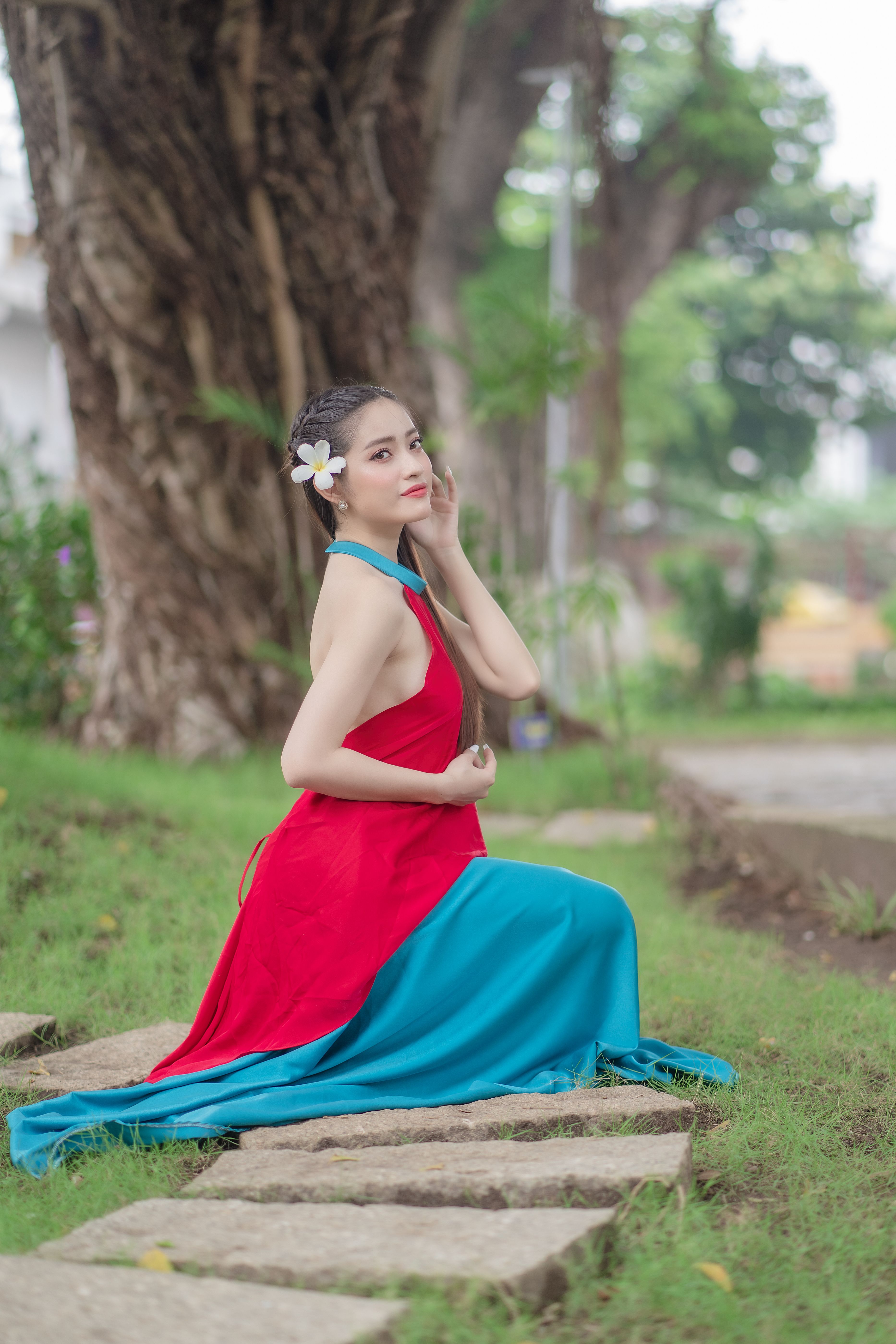 Young Model in a Red and Blue Dress with a Flower in Her Hair  Free Stock  Photo