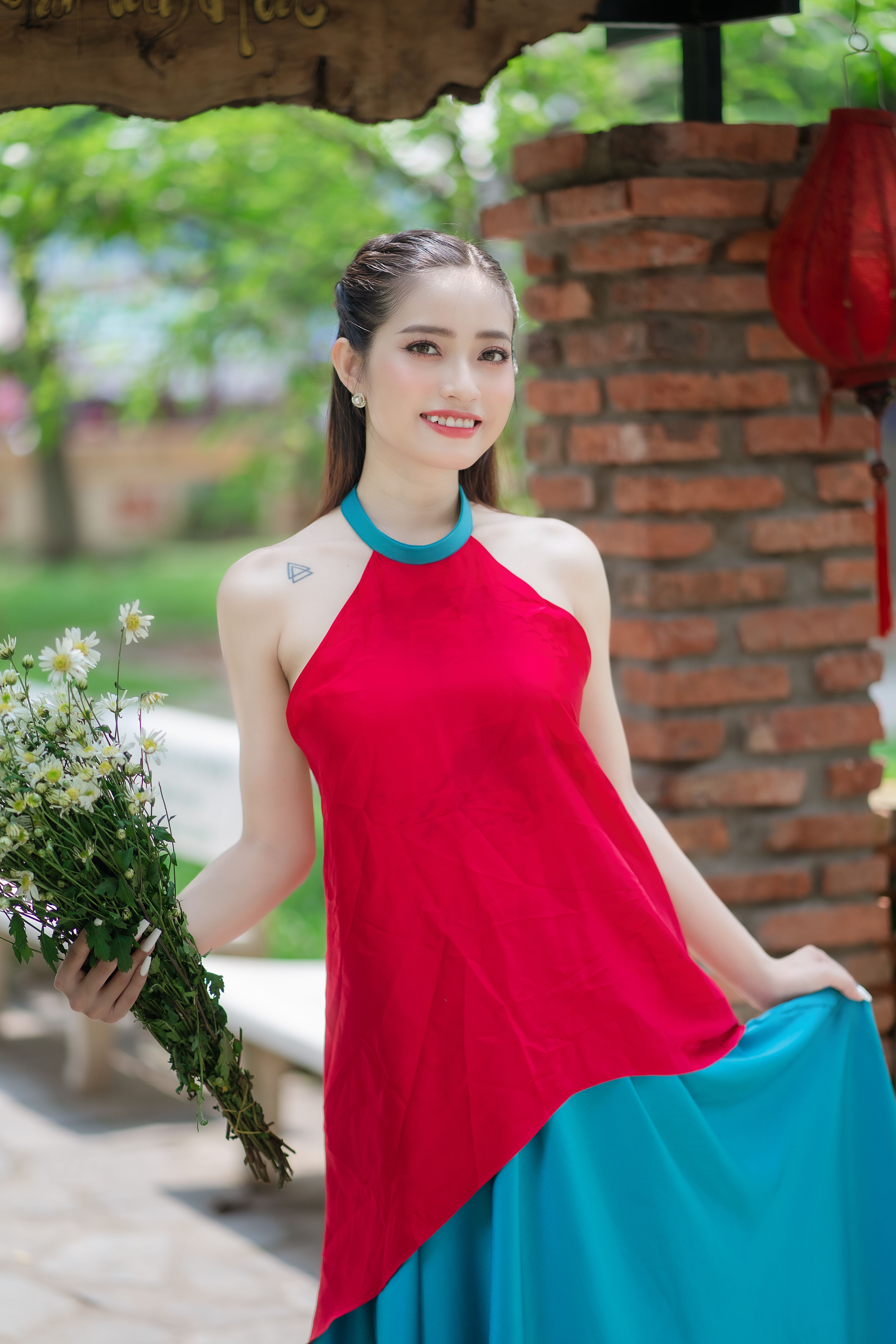 Young Model in a Red and Blue Dress with a Flower in Her Hair  Free Stock  Photo