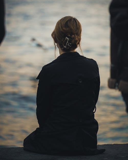 Woman in Black Coat in Seaside