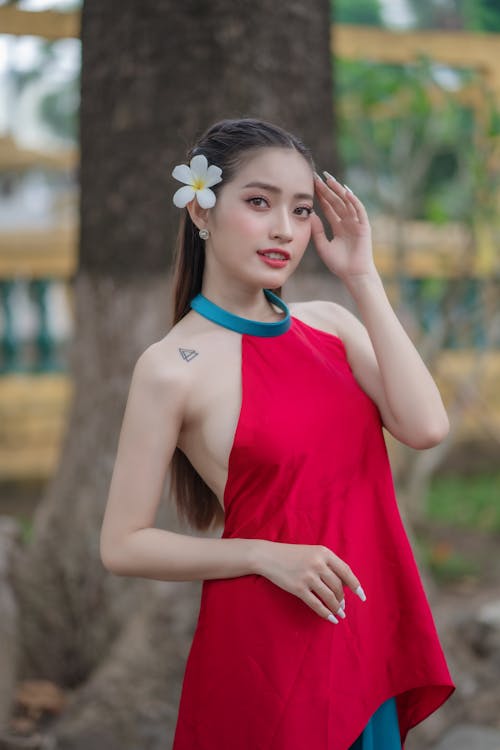 Young Model in a Red and Blue Dress with a Flower in Her Hair