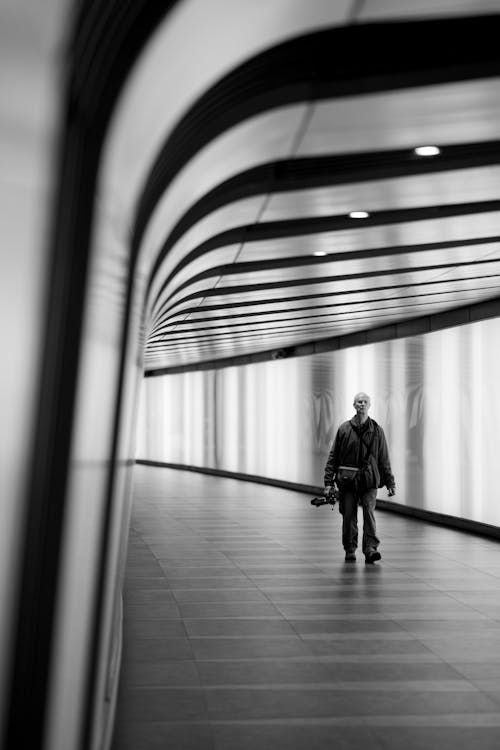 Man Walking in Tunnel in Black and White