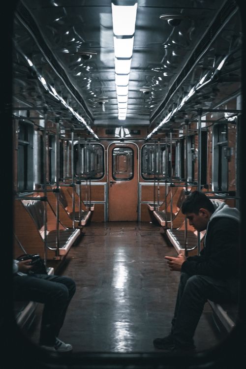 Free Interior of a Baku subway train with a focus on a solitary commuter engrossed in a mobile device. Stock Photo