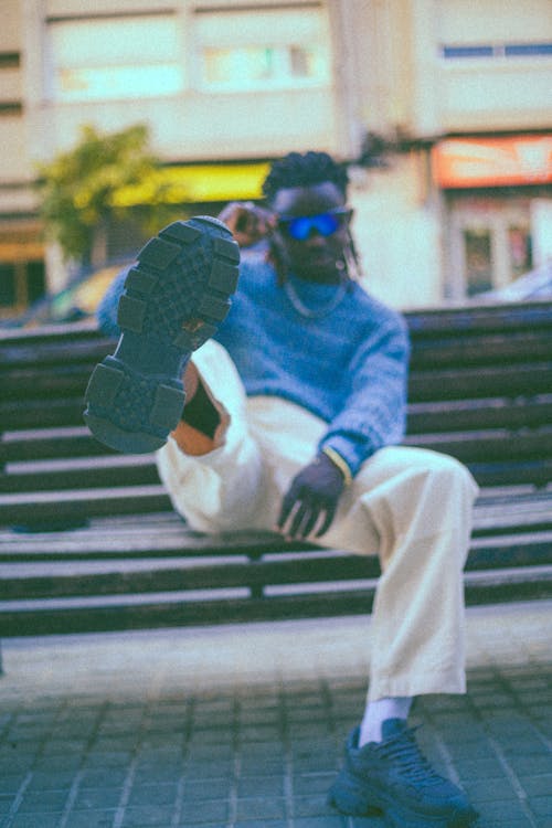 Man Sitting with Leg Raised on Bench