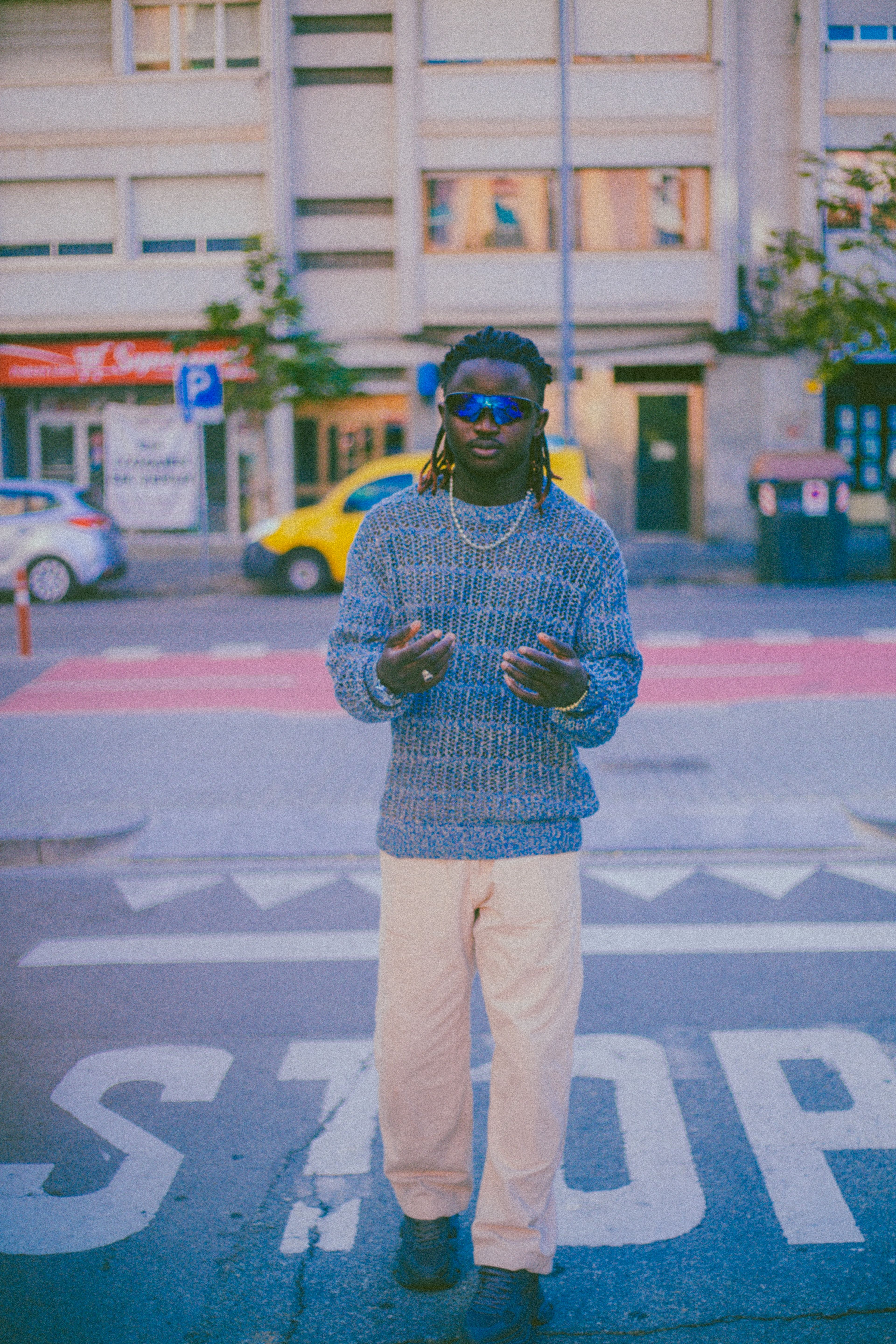 A fashionable man modeling an urban chic outfit on city streets, exuding style.