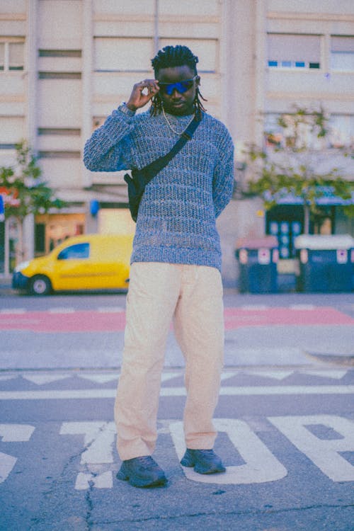 Man in White Pants and Black Sweater Free Stock Photo