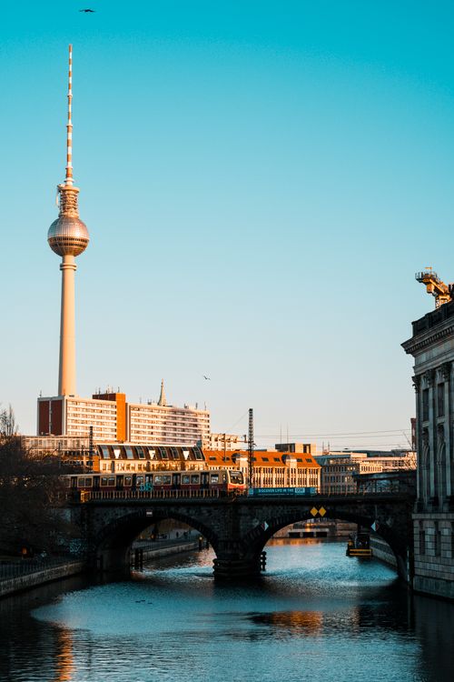 Free Scenic view of Berlin's Fernsehturm and bridge over the Spree River at sunset. Stock Photo