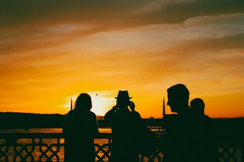 Silhouettes of People Looking at the Sunset