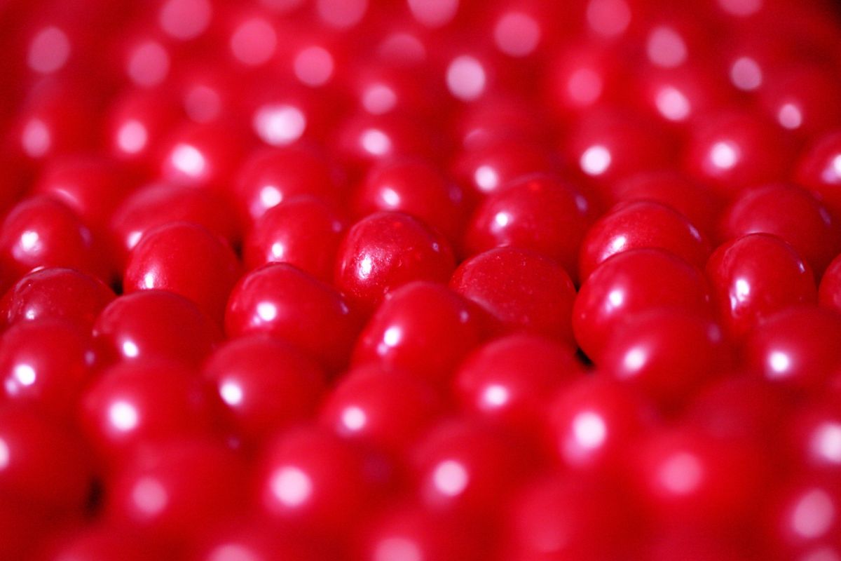 Vibrant close-up of red candy balls with a blurred background creating depth.