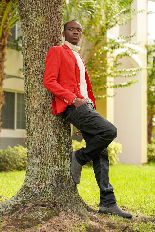 Elegant Man Standing by a Tree