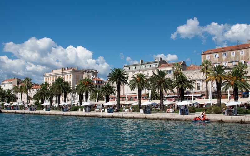 Split Riva waterfront promenade Croatia Adriatic palm trees boats evening