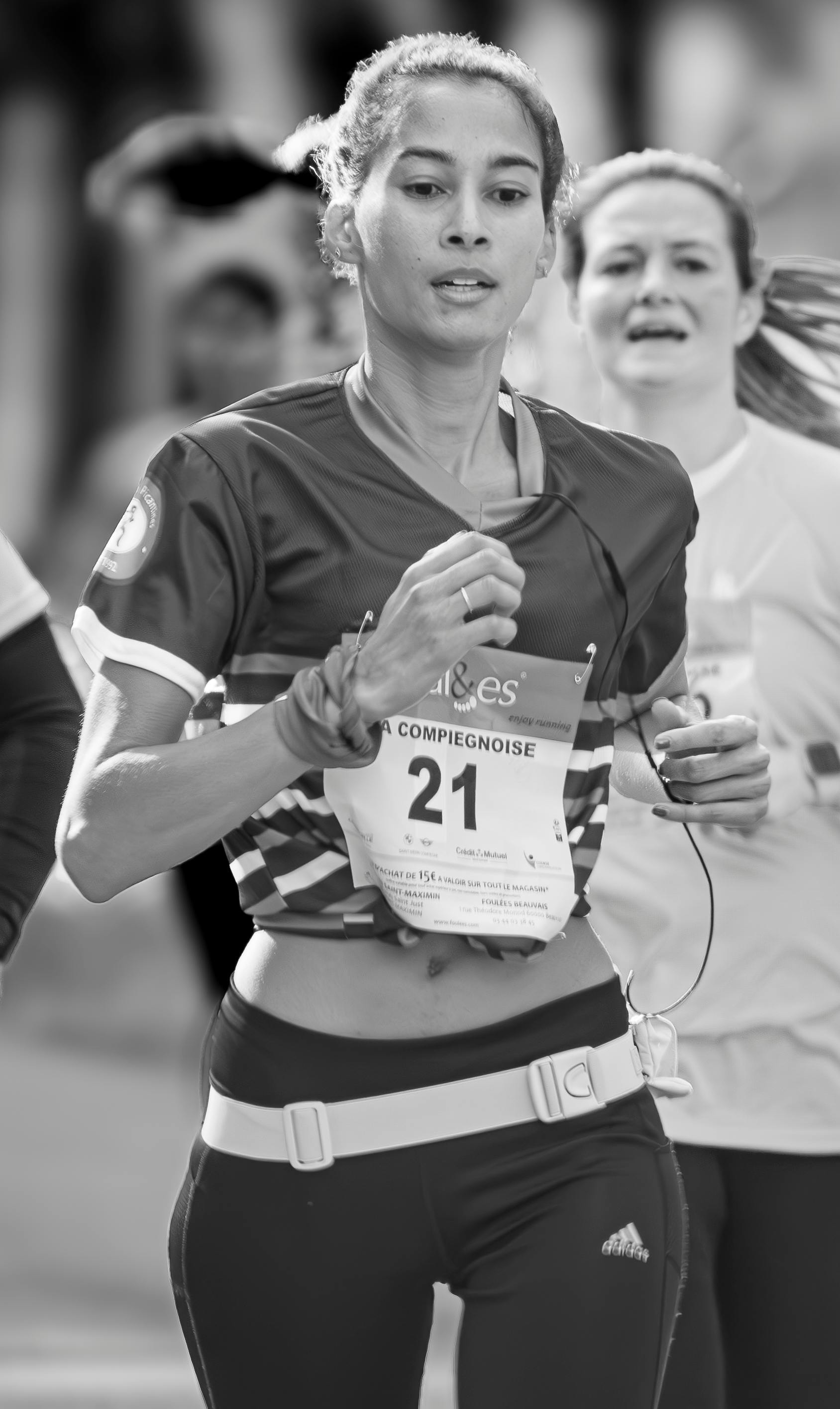 Powerful black and white photo of women in a marathon, capturing motion and determination.