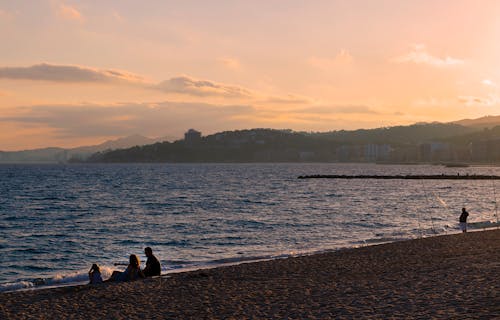 People Sitting on the Beach at Sunset